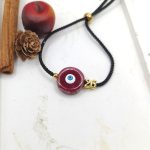 Βραχιόλι γούρι με κεραμικό μάτι μπορντό